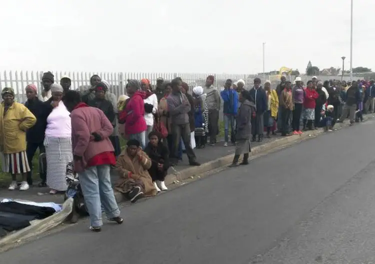 A social grant queue in Gugulethu, Cape Town. Postbank has introduced a new cardless payment. Image: GroundUp.
